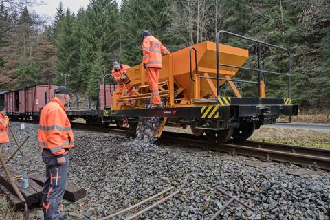 Der fehlende Schotter wird aus dem Schotterwagen im Arbeitszug bereitgestellt.