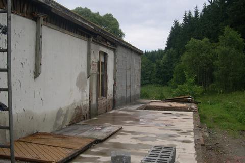 Der seitliche Anbau ist bis zur Bodenplatte abgetragen, die hintere Hallenecke bereits neu aufgebaut.